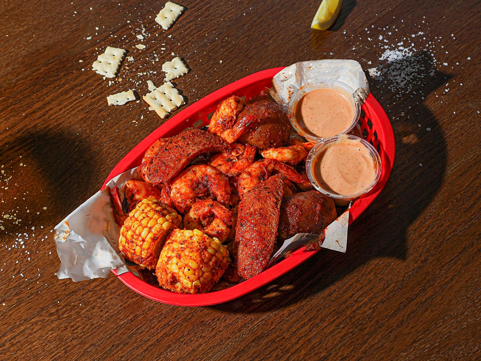 Shrimp boil with corn, potato, sausage and dipping sauces at BB’s Cajun Cantina